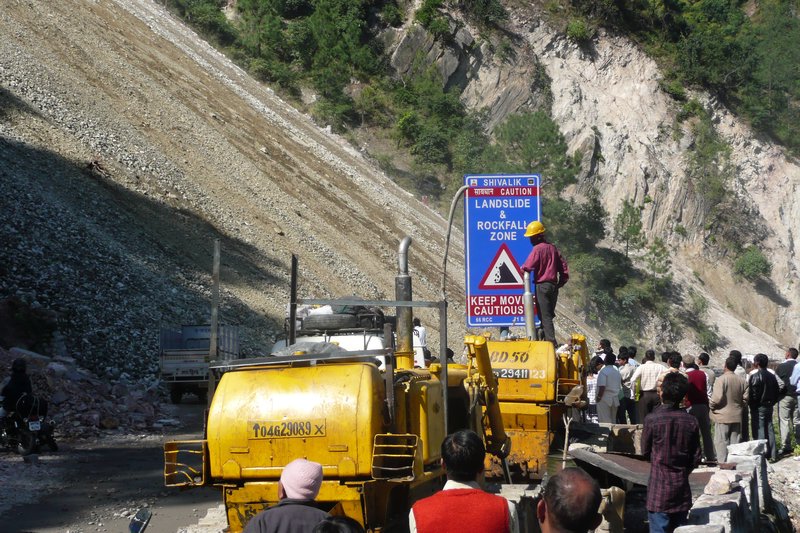 Trying to direct the traffic through the landslide in India