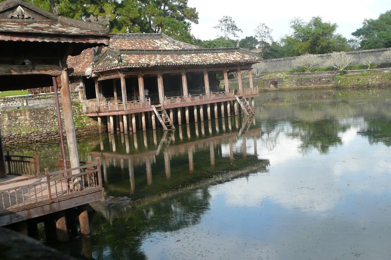 A wooden pavilion on a man-made lake