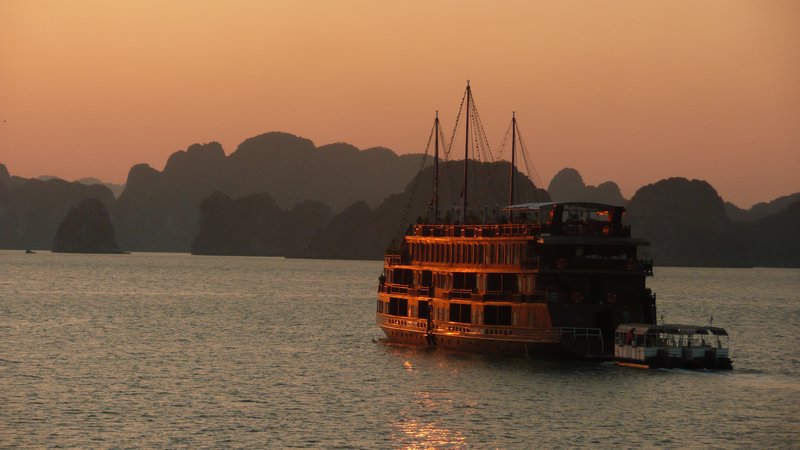 A traditional junk in Halong Bay at sunset