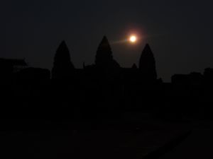 The full moon shines over the towers of Angkor Wat