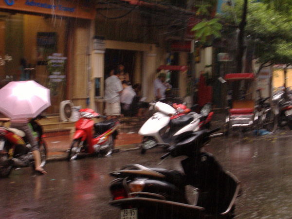 Street haircut in Hanoi under the rain