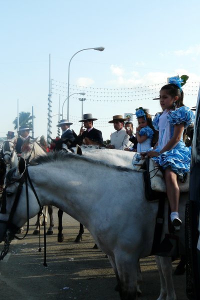 A line of horses, men and little girls