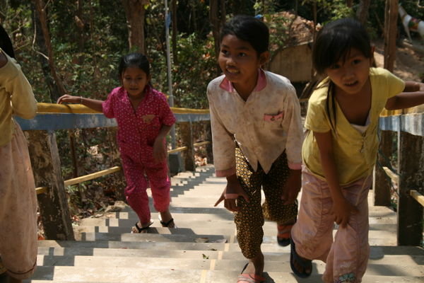 Children climbing stairs at temple near Kampi