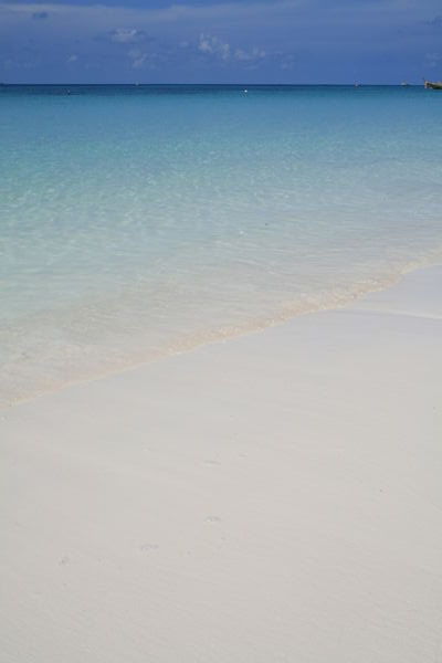 Perfect white sand fading to darkest blue