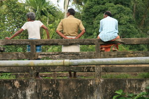 Three men on a bridge