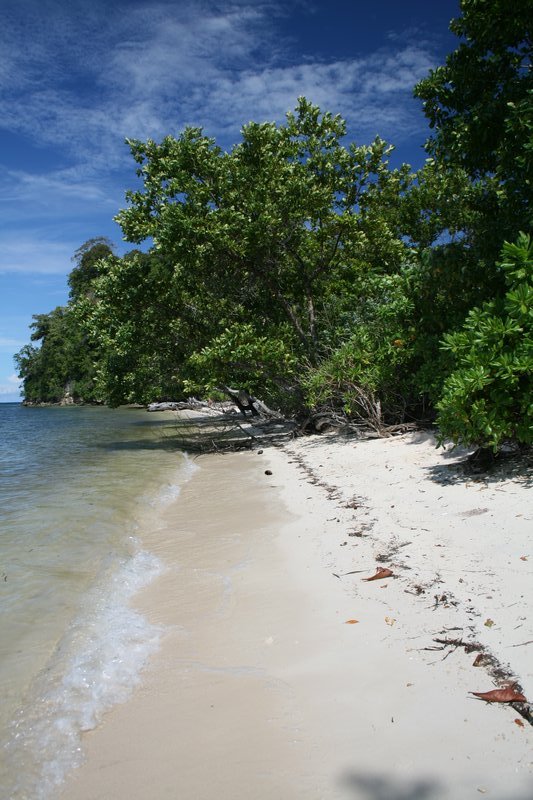 Deserted beach on the back of Pulau Tomken