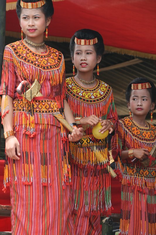Girls in traditional dress, welcoming guests at the funeral