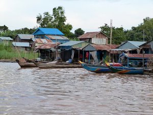 Sunset cruise on the Tonle Sap River, a floating village