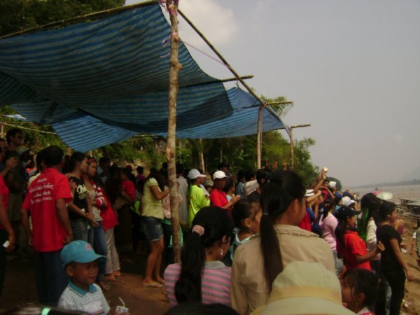 Laotian people celebrating, singing, dancing and cheering their favorite boat