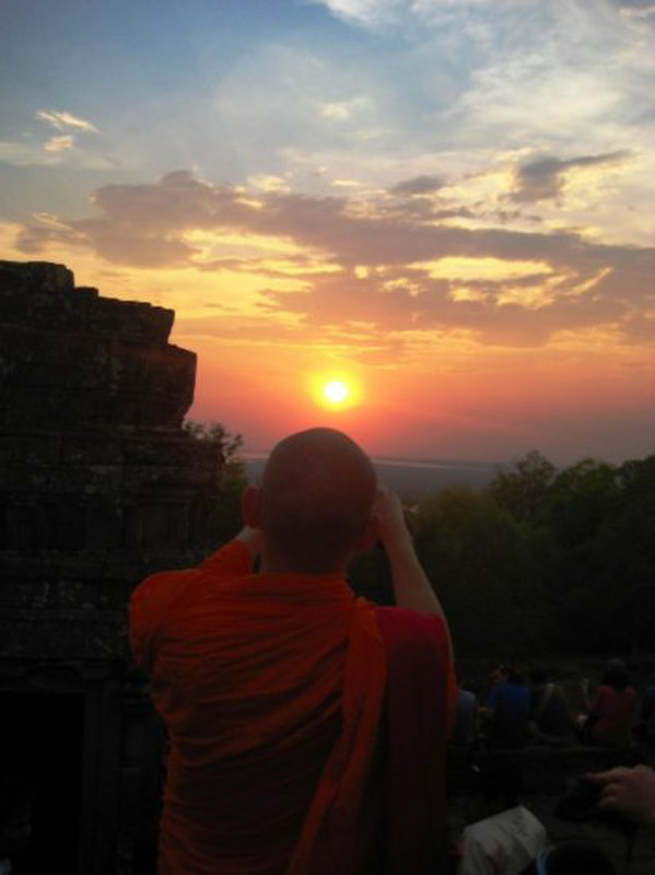 A monk at Phnom Bakheng at sunset