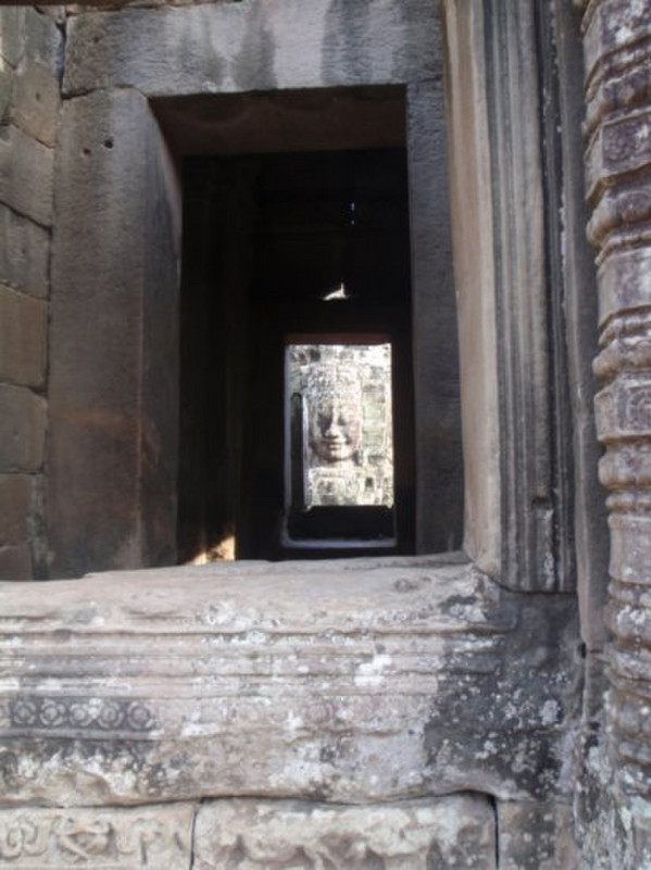 Bayon faces through one of the central rooms