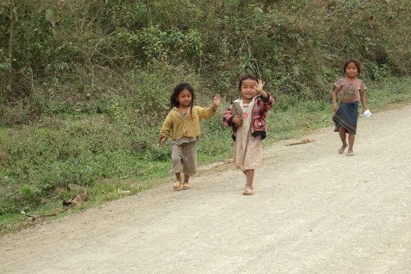 Village kids waving hello