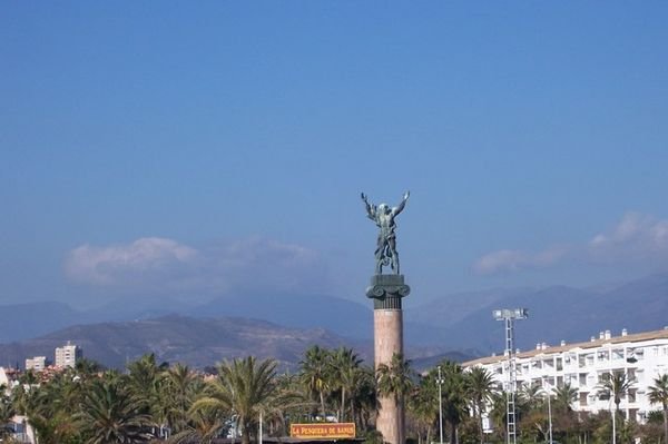 Statue with mountains behind