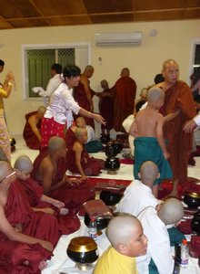 monks helping novices with robes