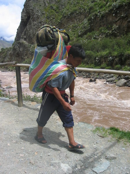 indigenous quechua porter pulls his weight for the tourist dollar