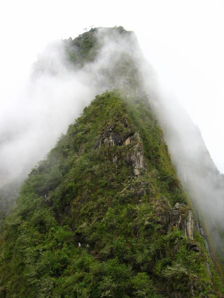 the top half of wayna picchu (young mountain) in the wispy clouds