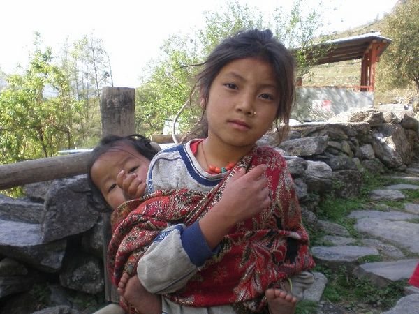 A Young Girl Carrying Her Sister
