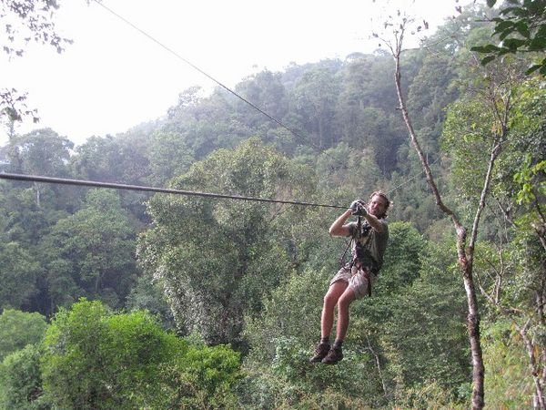 Chris reaching the end of a zip line