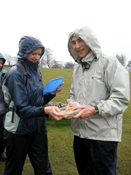 Di hands Ralph his lunch to keep up his stamina on the way to Pen-y-ghent. Pennine Way, Yorkshire