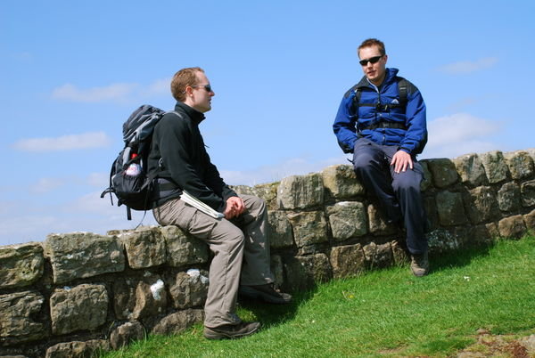 Brotherly chat on Hadrian's Wall. Pennine Way, Northumberland