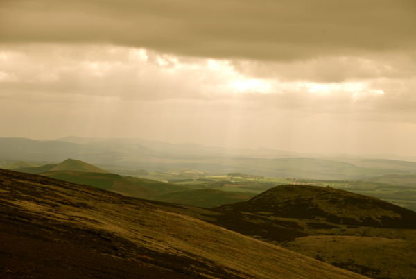 Moody skies, with rays of sunshine over the mountains. Pennine Way, Northumberland