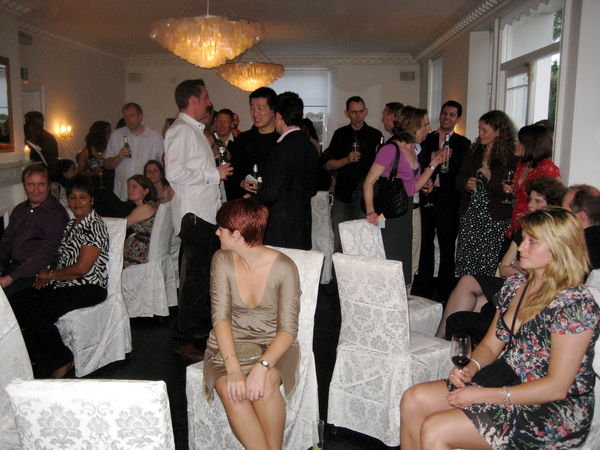 Guests waiting for raffle to begin in the White Room, Beauberry House. Dulwich, London