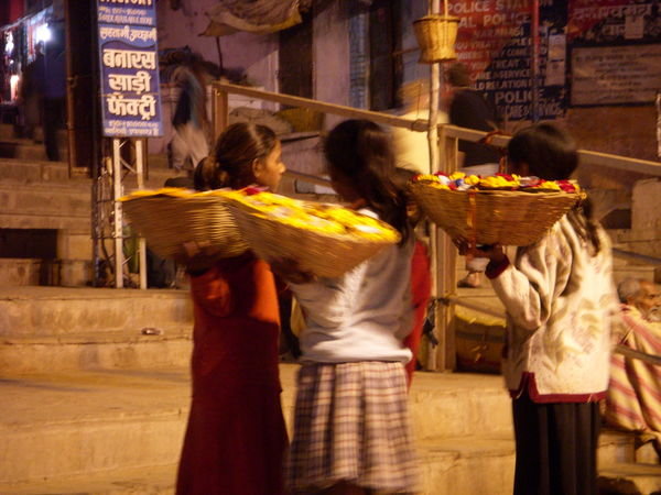 Girls selling candle flowers for the river