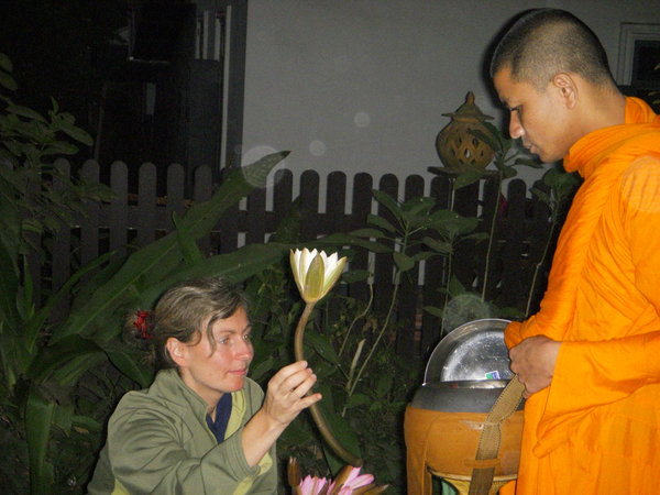 Cathy offering a lotus to monk