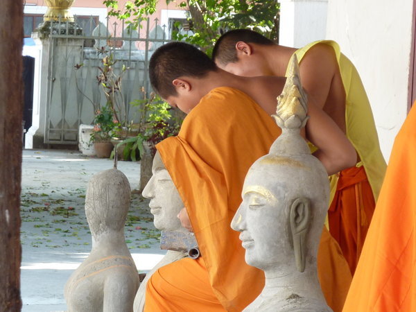 Monks working on the Buddhas