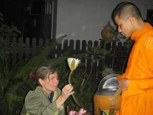 Cathy offering a lotus to monk