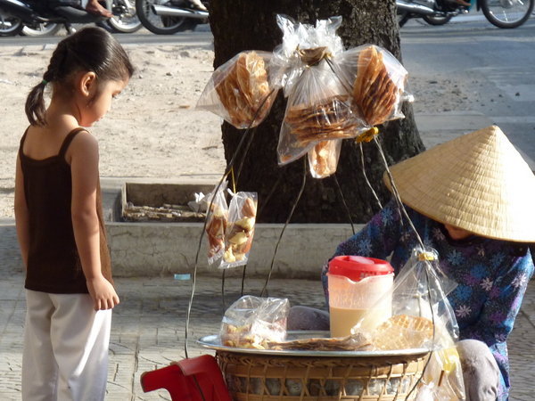 Little girl buying a treat in Saigon