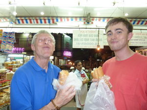 Steve and Jered trying out some pork sandwiches in Saigon