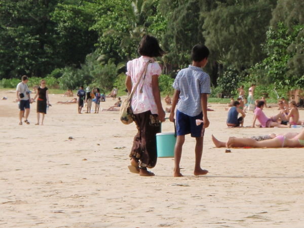 Cute kids selling drinks on the beach