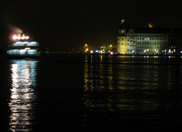 Hydarpaşa Train Station with a ferry passing by at night
