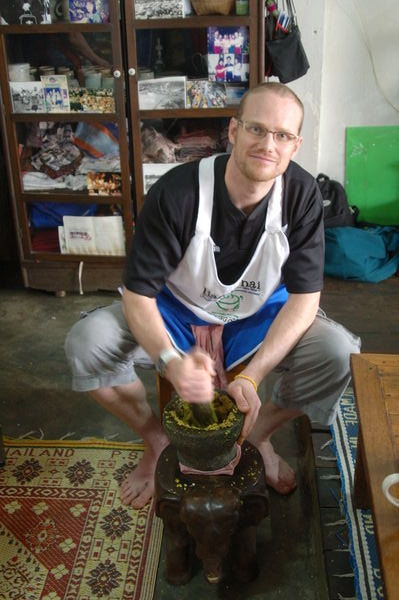 Tom making green curry paste