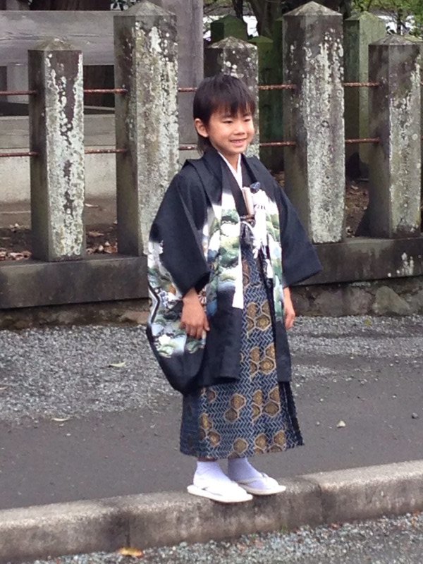 Pretty little girl outside Shinto Shrine in Aso. 