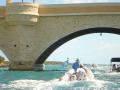 Dinghies Going Under Crab Cay Bridge