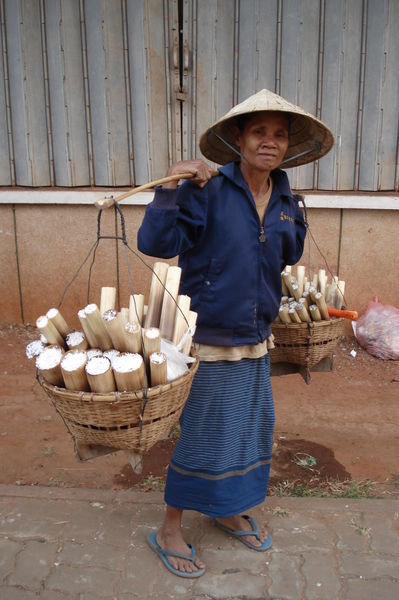 Laotian woman selling coconut sticky rice