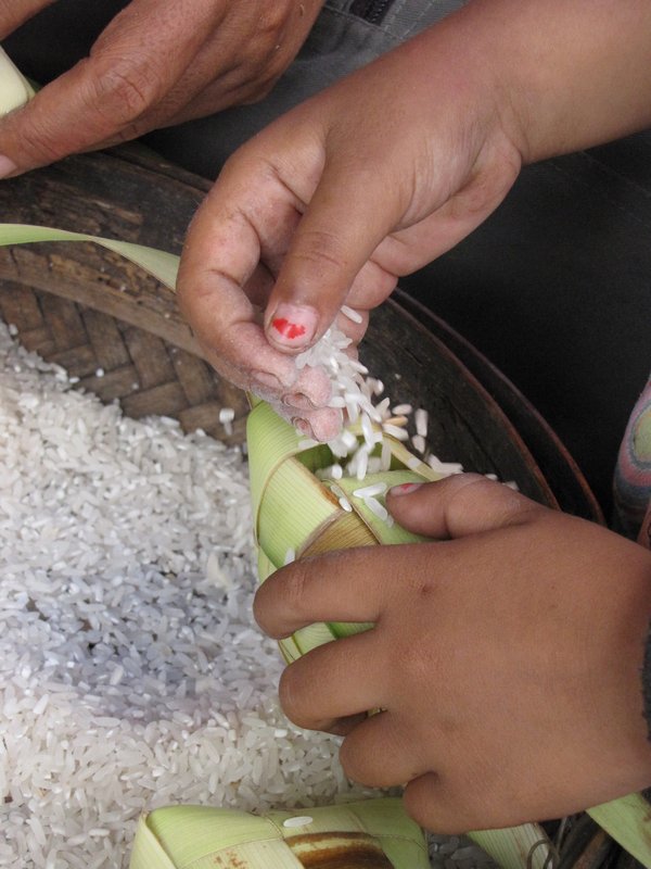 Little girl helping fill them with rice