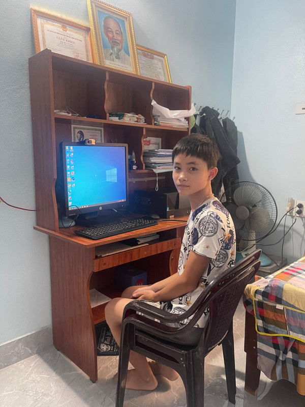 Khang with a new computer presented by donors
