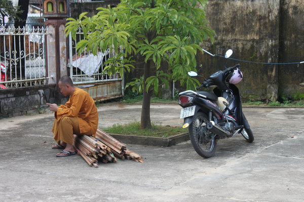 Monk and motorbike at a pagoda in Tam Kỳ city