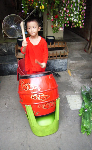 A kid beating drum