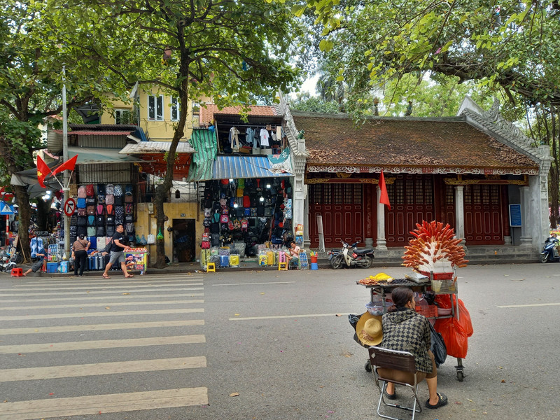 A street vendor and shops in Hanoi centre