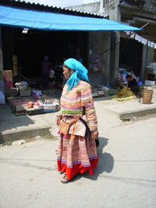 A H'mong woman passing by the shops