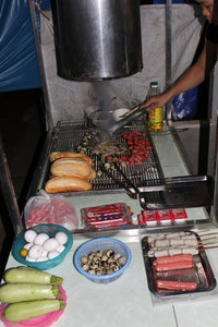 Grilling food for sale at night in Bát Xát town