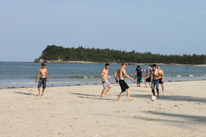 Playing football at Minh Châu beach