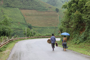 A H'mong family is walking on Highway No. 32