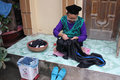 A Tày ethnic woman is sewing dress
