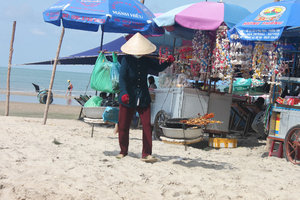 Selling grilled squids at a beach in Long Hải town