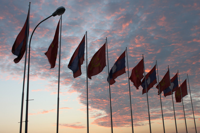 Flags at sunset by the Mekong river in Vientiane
